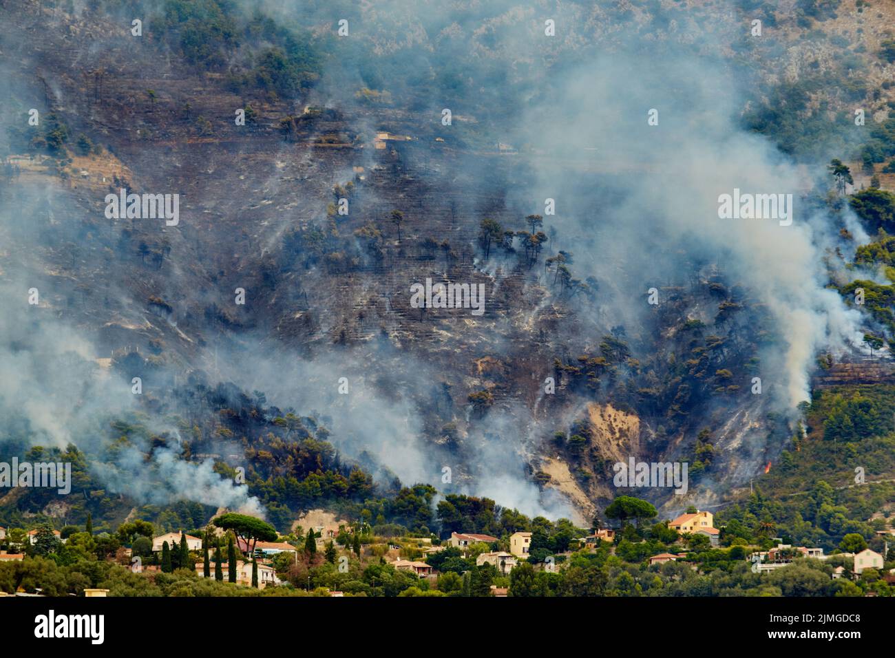 Fire in the forest mountain in the Italian town of Ventimiglia, all the mountains in the smoke, the villa is on fire, the fire s Stock Photo