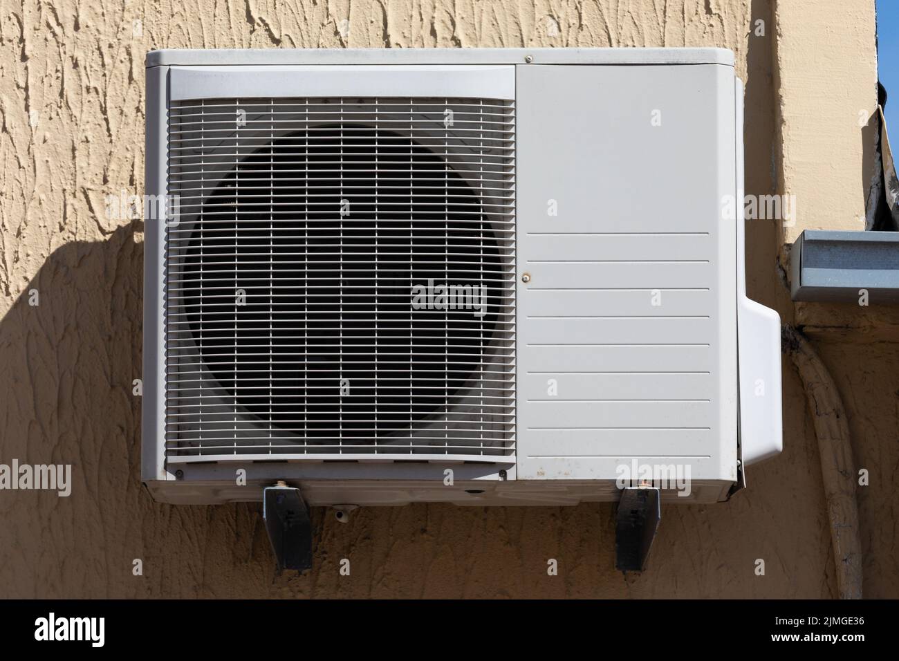 outdoor unit of a domestic air conditioner with a fan outside the