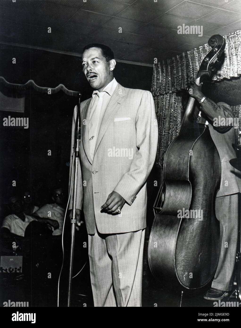 A rare photo of jazz singer Billy Eckstine on stage in a club likely in the 1950s. Stock Photo