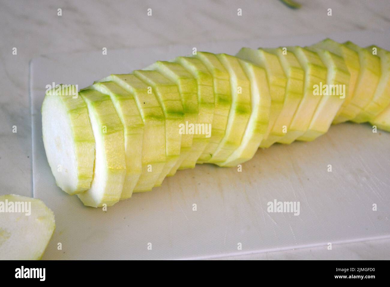 Healthy food, vegetables, peeled zucchini cut into rings and cubes are
