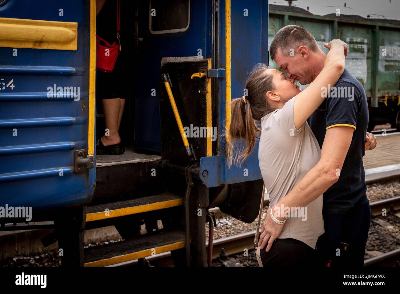 A boyfriend kisses and bids farewell to his girlfriend before she departs to Dnipro by the evacuation train at Pokorvsk Train Station, Donetsk. Amid the intensified fighting in the Eastern part of Ukraine, east Ukraine is now intensifying its civilian evacuation, as millions of Ukrainian families have been evacuating from the closer and closer war, as many of them will be relocated to the western part of the country. According to the United Nations, at least 12 million people have fled their homes since Russia's invasion of Ukraine, while seven million people are displaced inside the country. Stock Photo