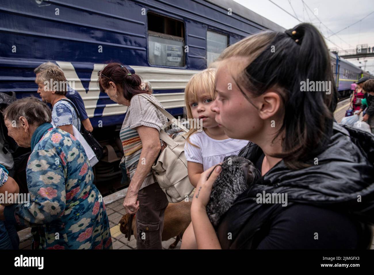 A mother holds her daughter boarding the evacuation train at Pokorvsk Train Station, Donetsk. Amid the intensified fighting in the Eastern part of Ukraine, east Ukraine is now intensifying its civilian evacuation, as millions of Ukrainian families have been evacuating from the closer and closer war, as many of them will be relocated to the western part of the country. According to the United Nations, at least 12 million people have fled their homes since Russia's invasion of Ukraine, while seven million people are displaced inside the country. Stock Photo