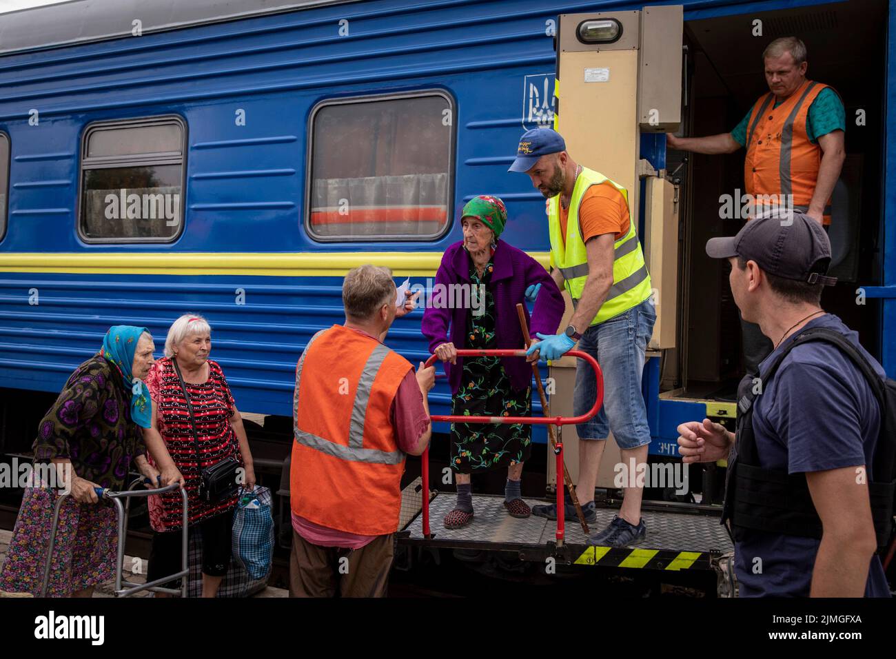 Volunteers assisting the elders to board the evacuation train at Pokorvsk Train Station, Donetsk. Amid the intensified fighting in the Eastern part of Ukraine, east Ukraine is now intensifying its civilian evacuation, as millions of Ukrainian families have been evacuating from the closer and closer war, as many of them will be relocated to the western part of the country. According to the United Nations, at least 12 million people have fled their homes since Russia's invasion of Ukraine, while seven million people are displaced inside the country. Stock Photo
