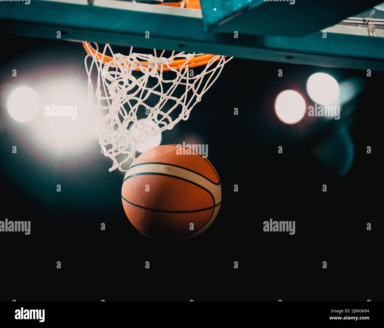 Basketball game ball in hoop Stock Photo Alamy