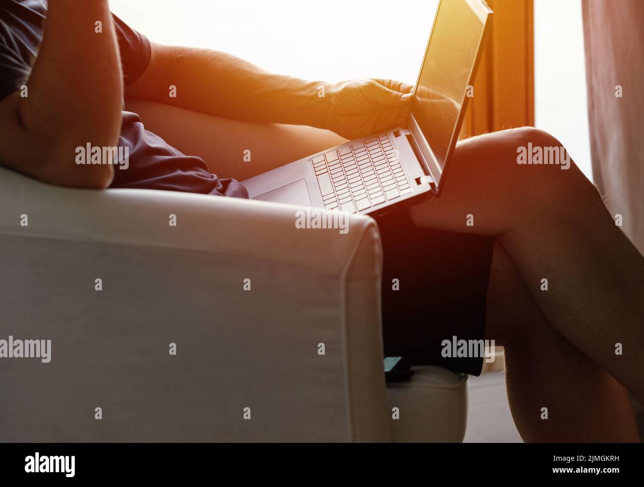 Working from home on the laptop. Wearing casual comfort outfit in home office. Stock Photo