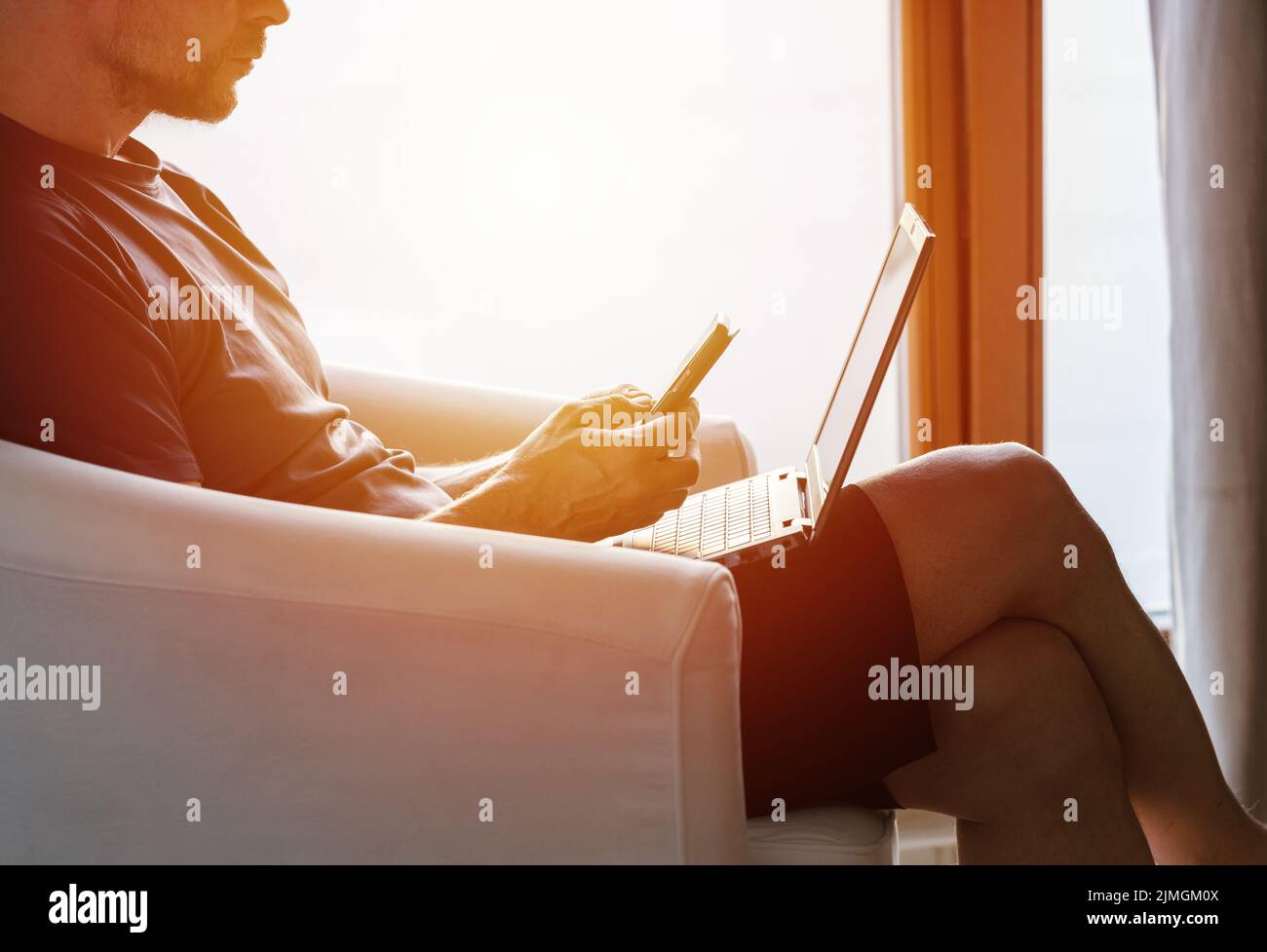 Working from home on the laptop. Wearing casual comfort outfit in home office. Stock Photo