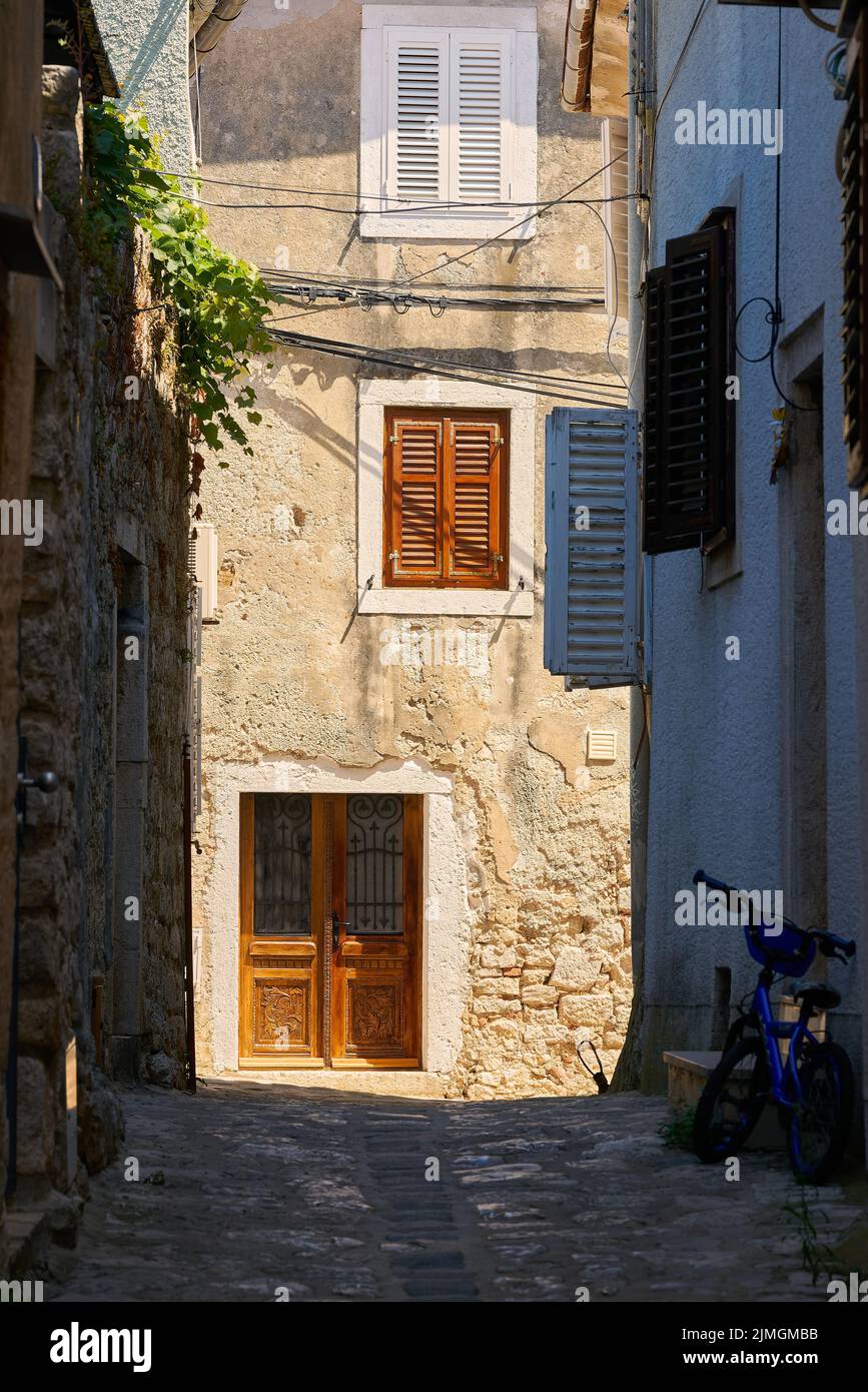 Historical for the region typical house in an alley in the old town of Krk in Croatia Stock Photo
