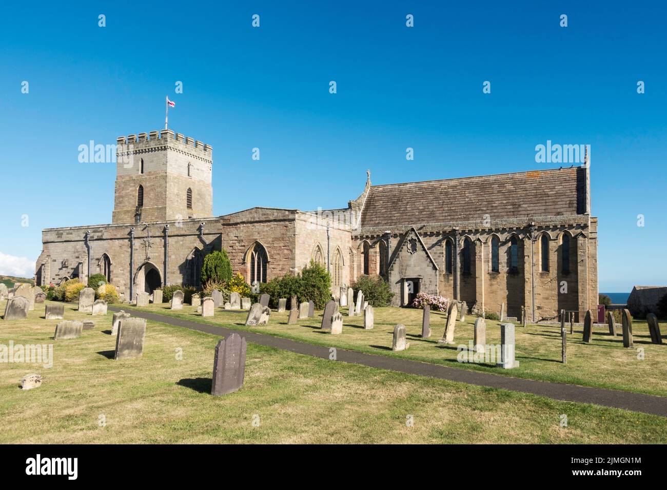The Parish Church of St. Aidan a grade I listed building in Bamburgh, Northumberland, England, UK Stock Photo