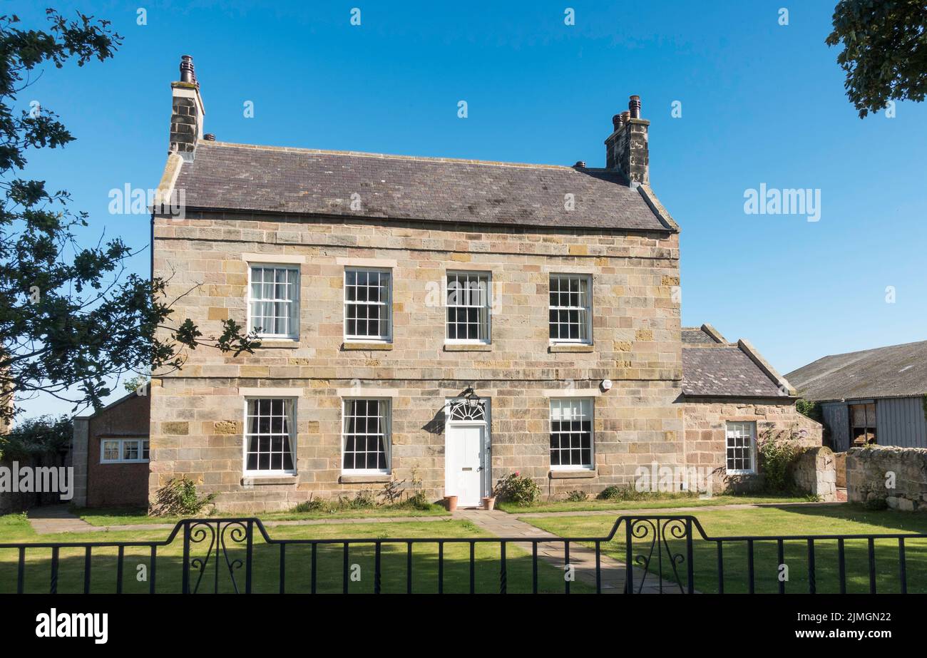 Bamburgh Hall, a listed building in Bamburgh, Northumberland, England, UK Stock Photo