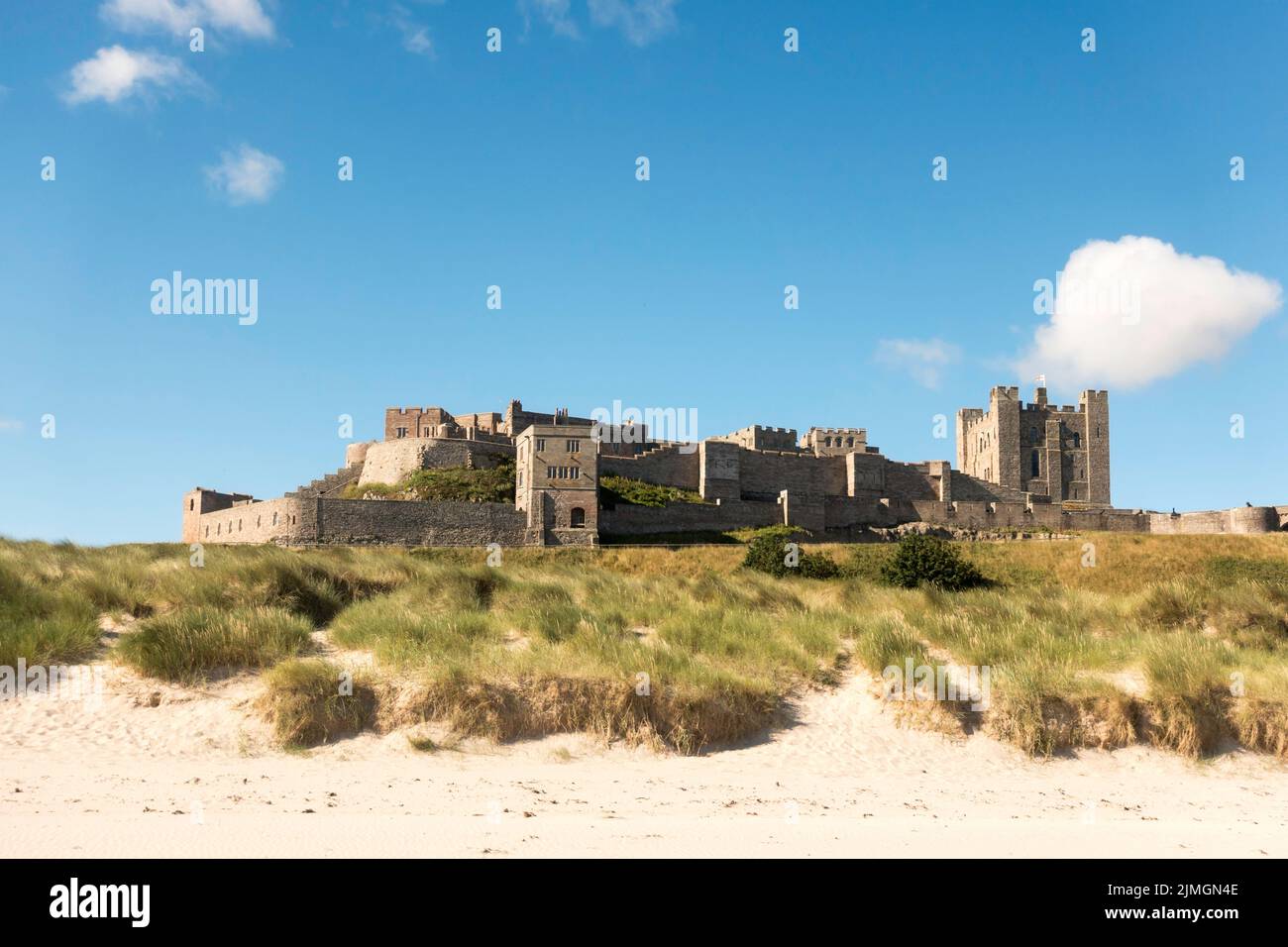 East facade of Bamburgh castle seen from the beach, Northumberland, England, UK Stock Photo