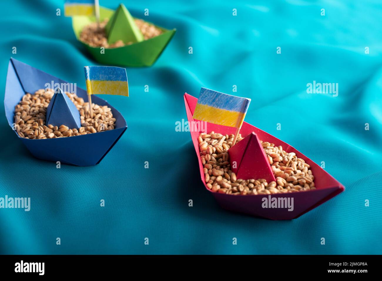 Ships with Ukrainian wheat grain made of paper concept Stock Photo
