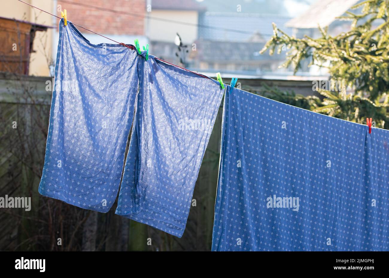 Bedsheets hanging on clothesrack outdoors Stock Photo