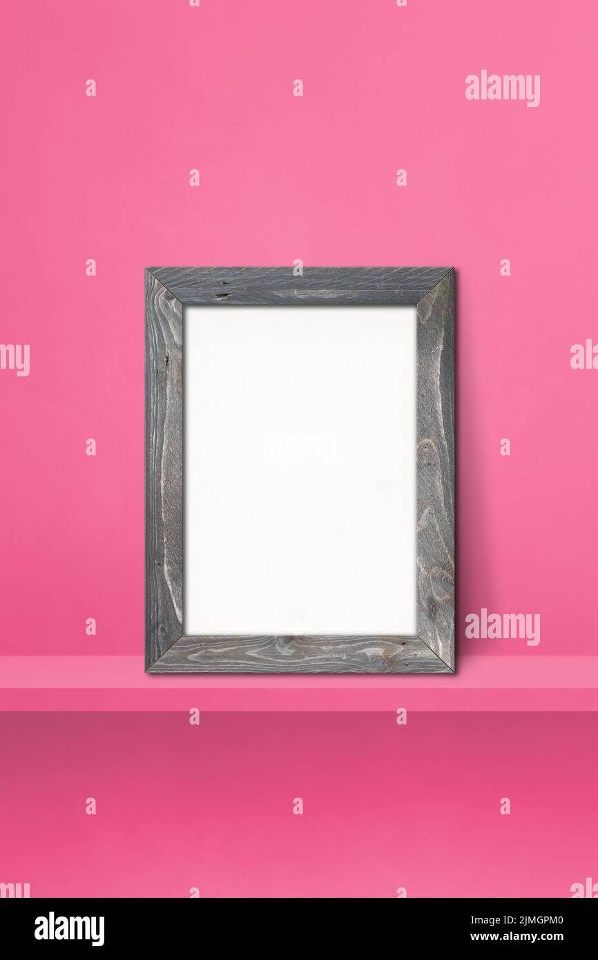 Wooden picture frame leaning on a pink shelf. 3d illustration. Vertical background Stock Photo