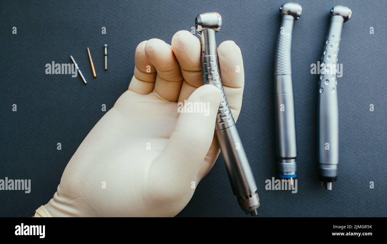 tools dentist hand holding dental handpiece Stock Photo Alamy