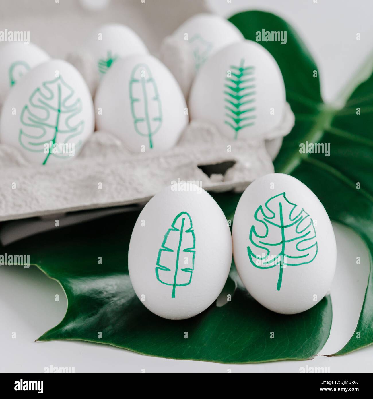 Tropical leaves drawings on easter eggs Stock Photo