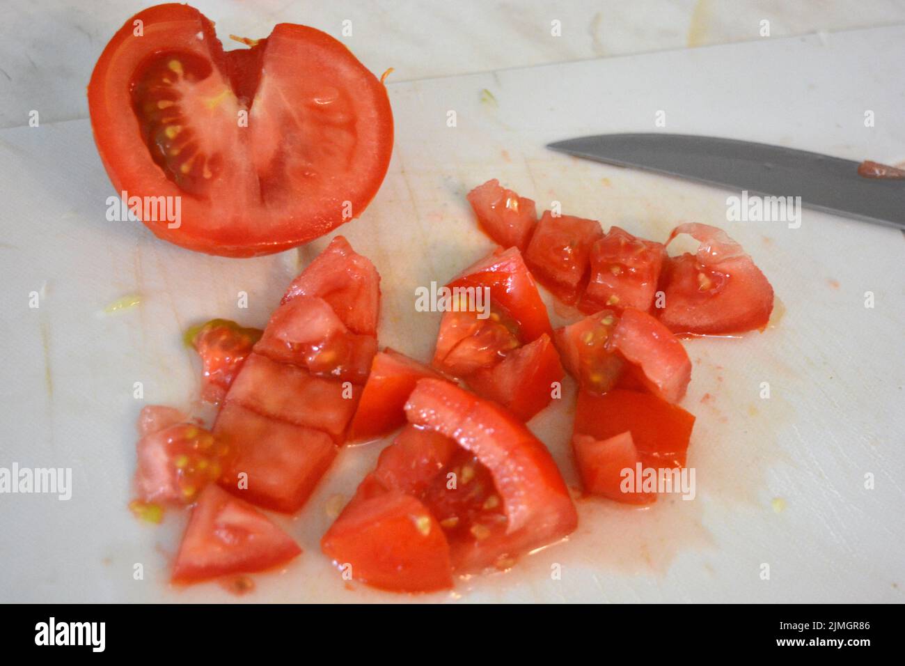 Healthy food, vegetables, large red tomatoes cut into slices or covered