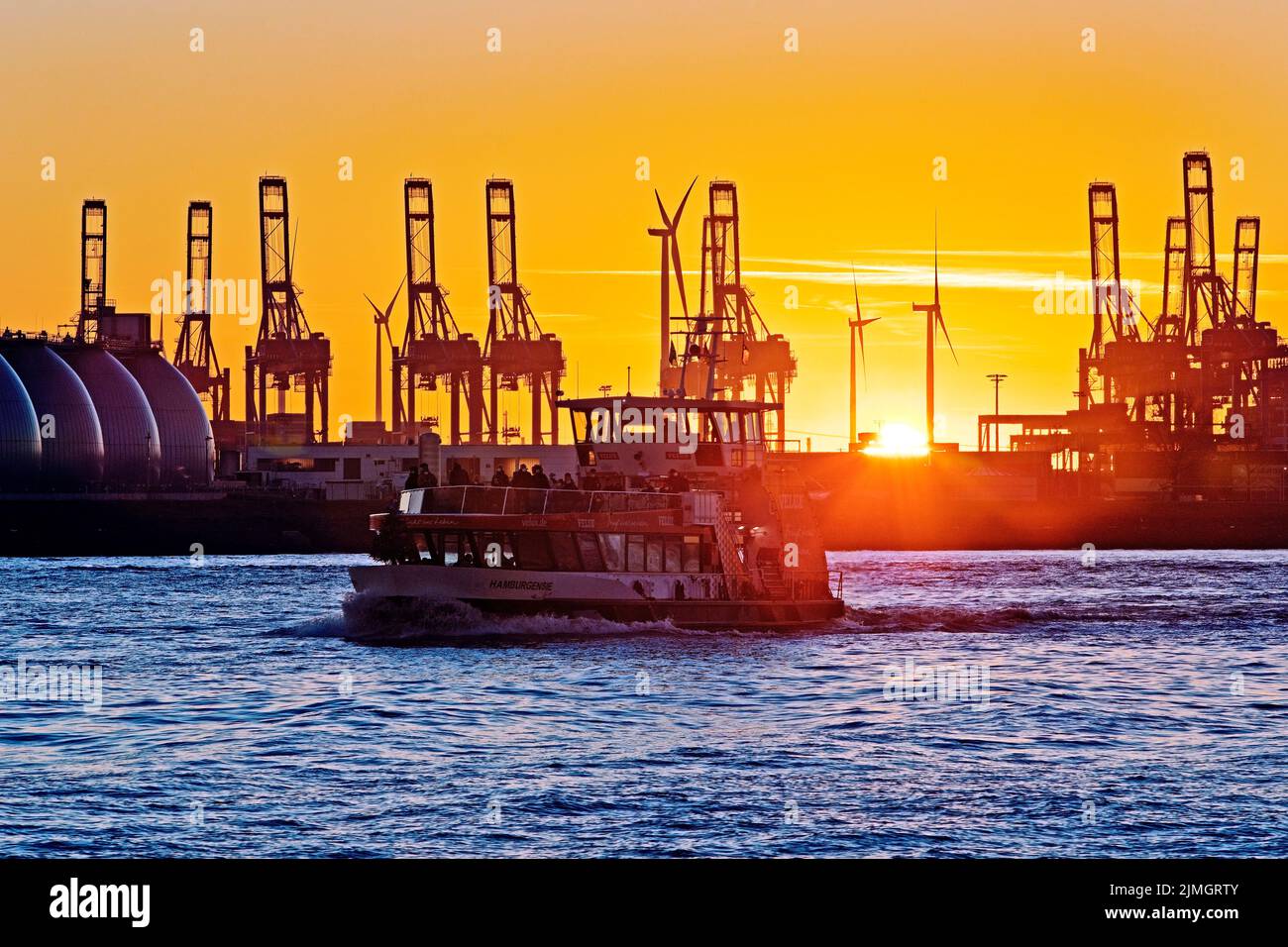 Excursion ship in front of loading cranes at the container terminal at ...
