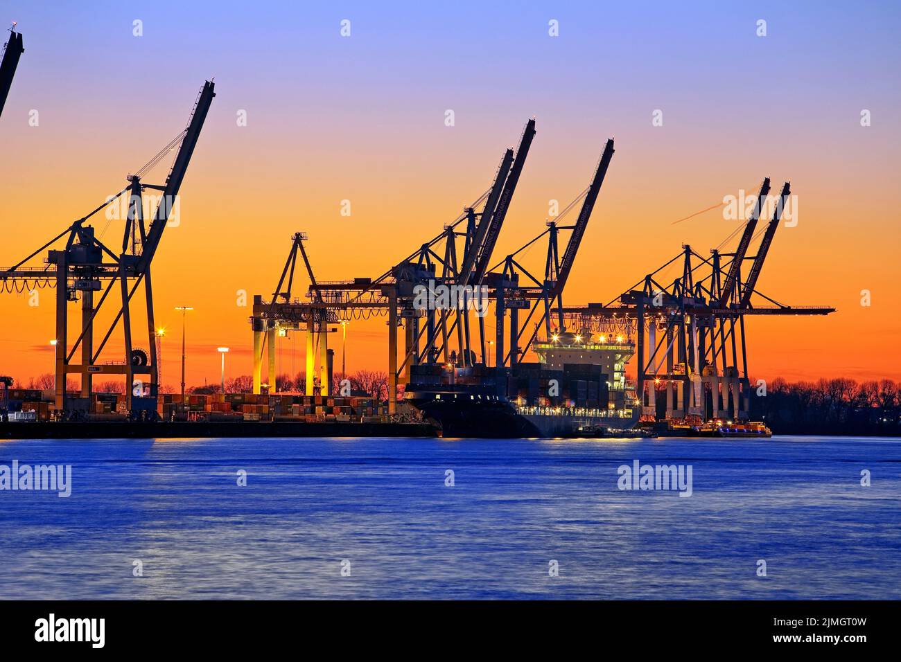 Loading cranes at the Burchardkai container terminal at sunset, Port of Hamburg, Germany, Europe Stock Photo