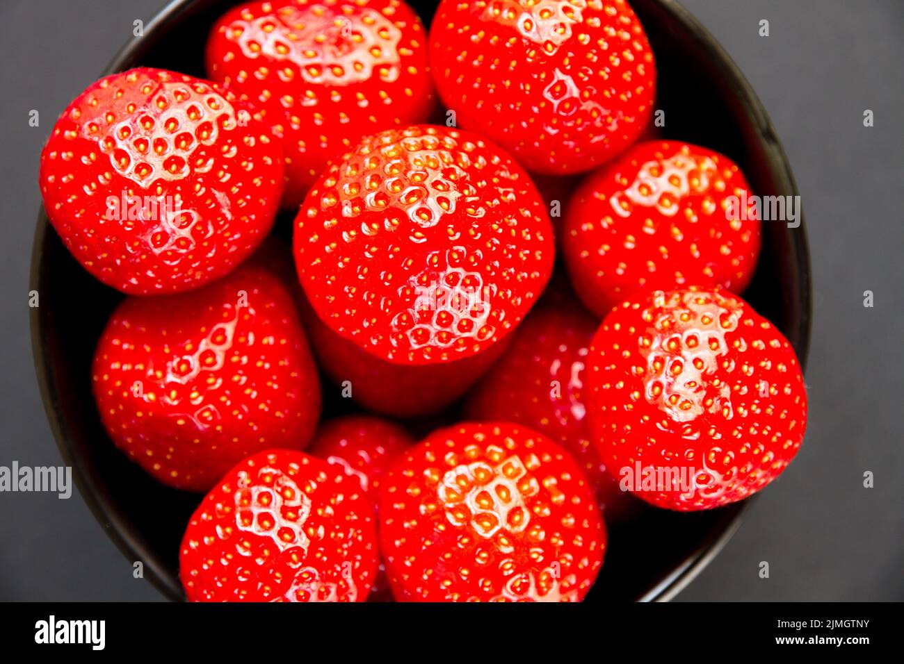 Strawberries in a bowl. Black background Stock Photo