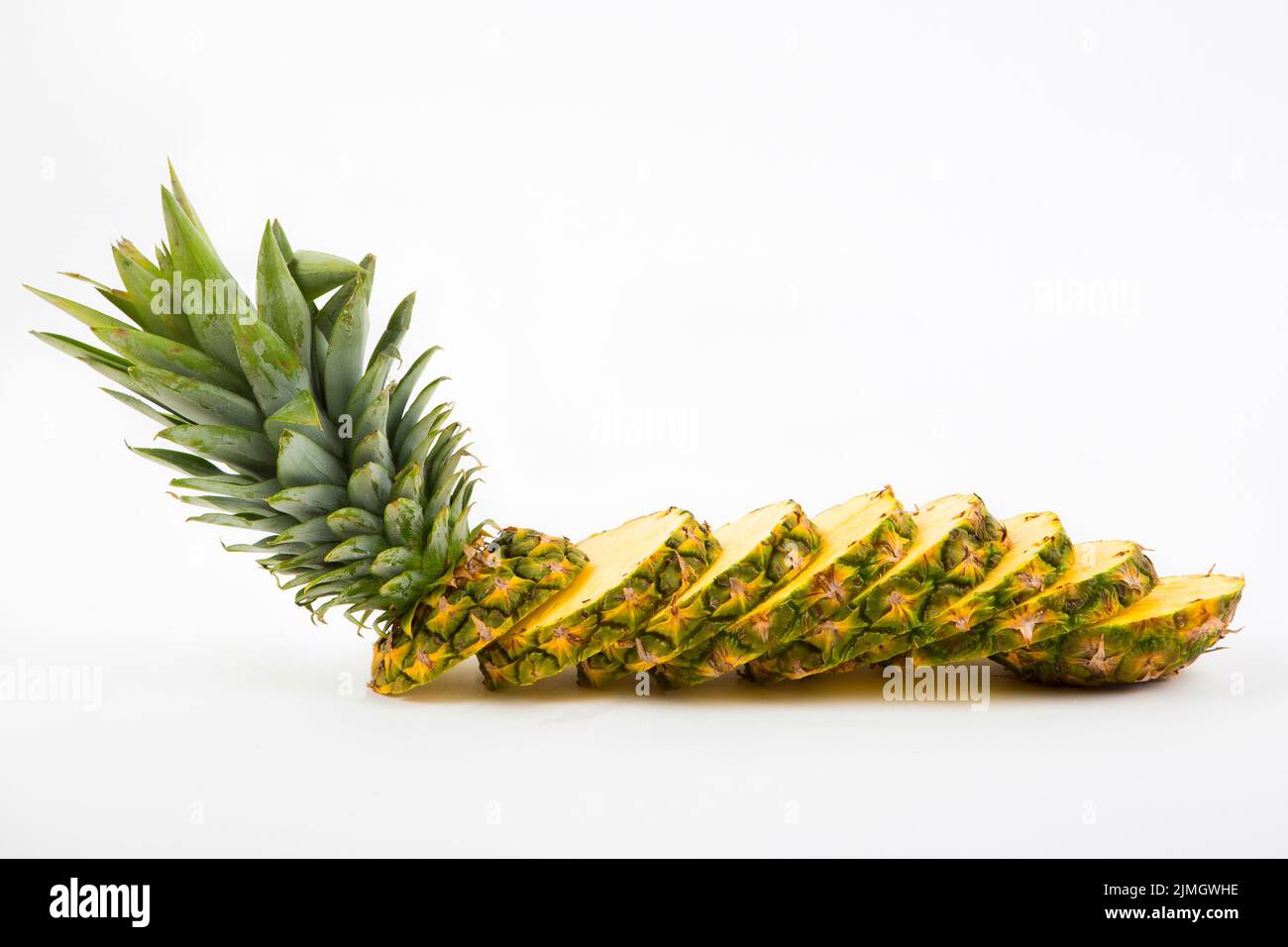 Pineapple with slices on a white background Stock Photo