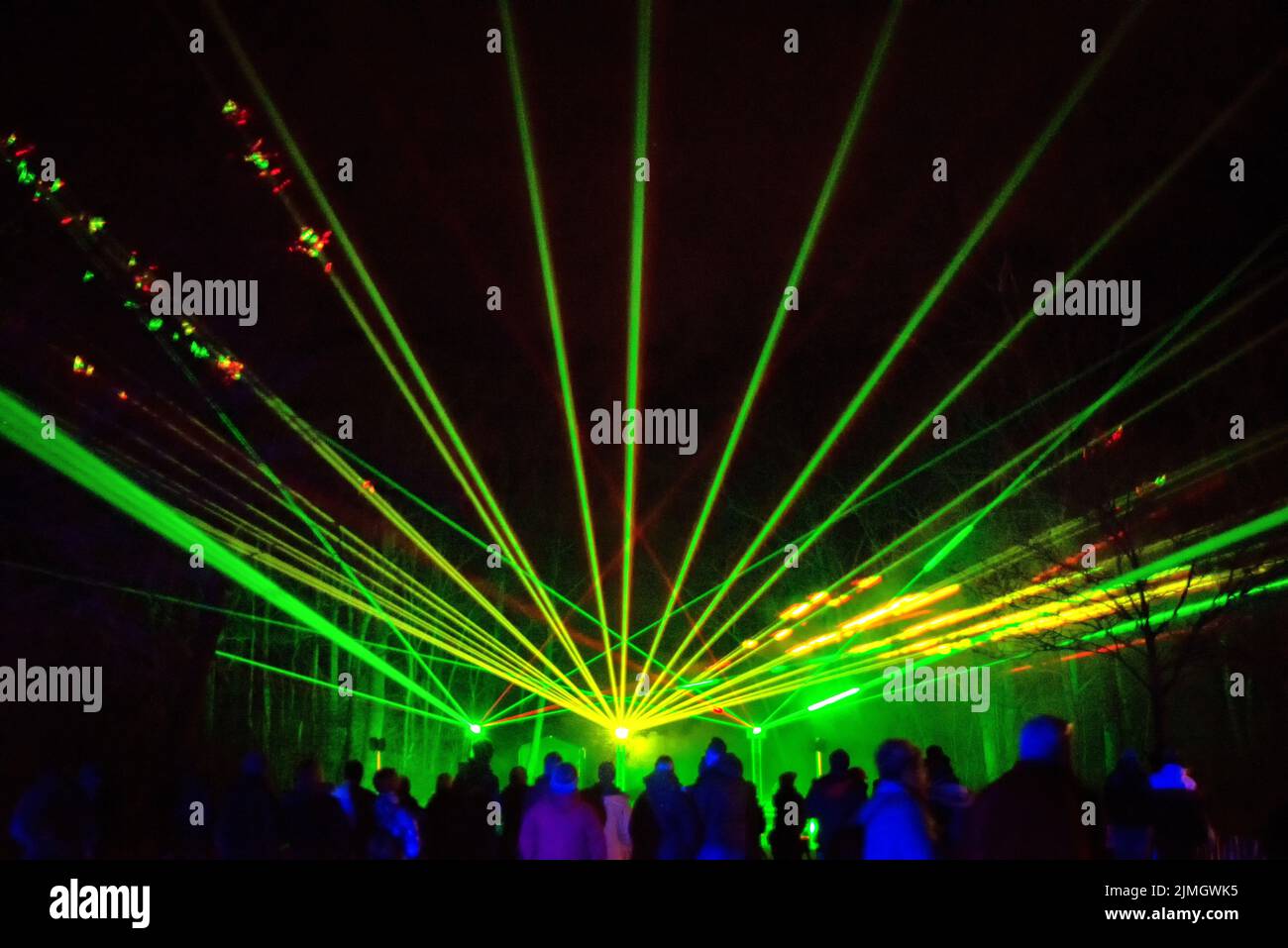 Green and red laser beams on a black background Stock Photo