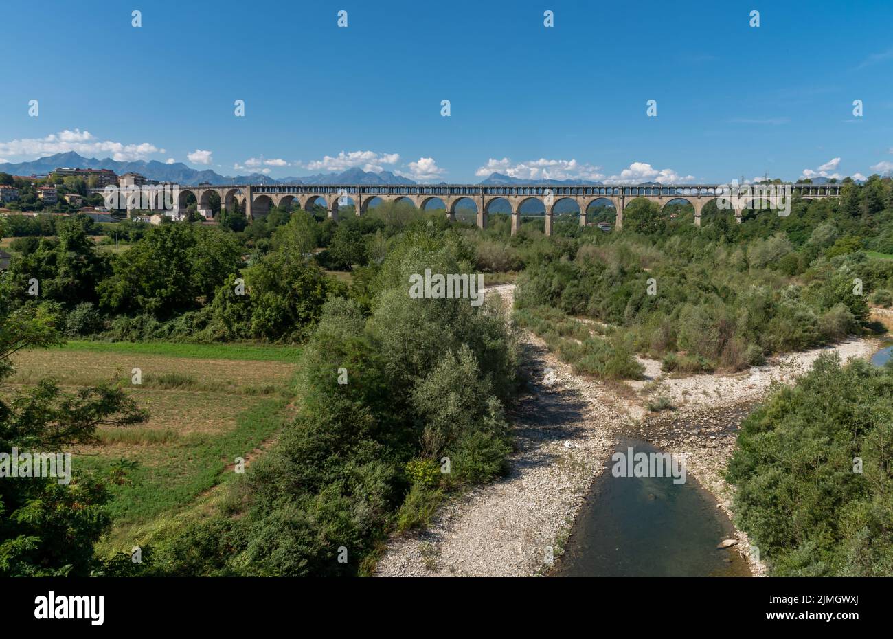 Cuneo, Piedmont, Italy - August 06, 2022: The Soleri viaduct, it is a promiscuous road and rail bridge on the Stura di Demonte river, in the backgroun Stock Photo