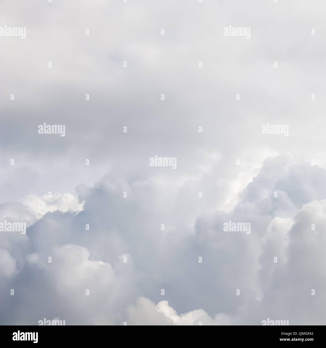 Cloudy sky background. Sunlight shining through white clouds. Stock Photo