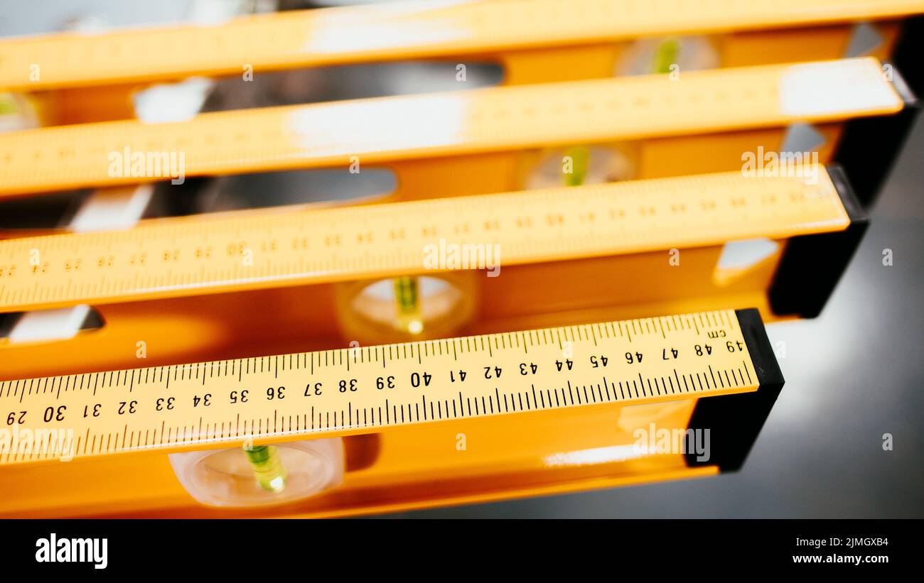 construction level rulers displayed tool store Stock Photo