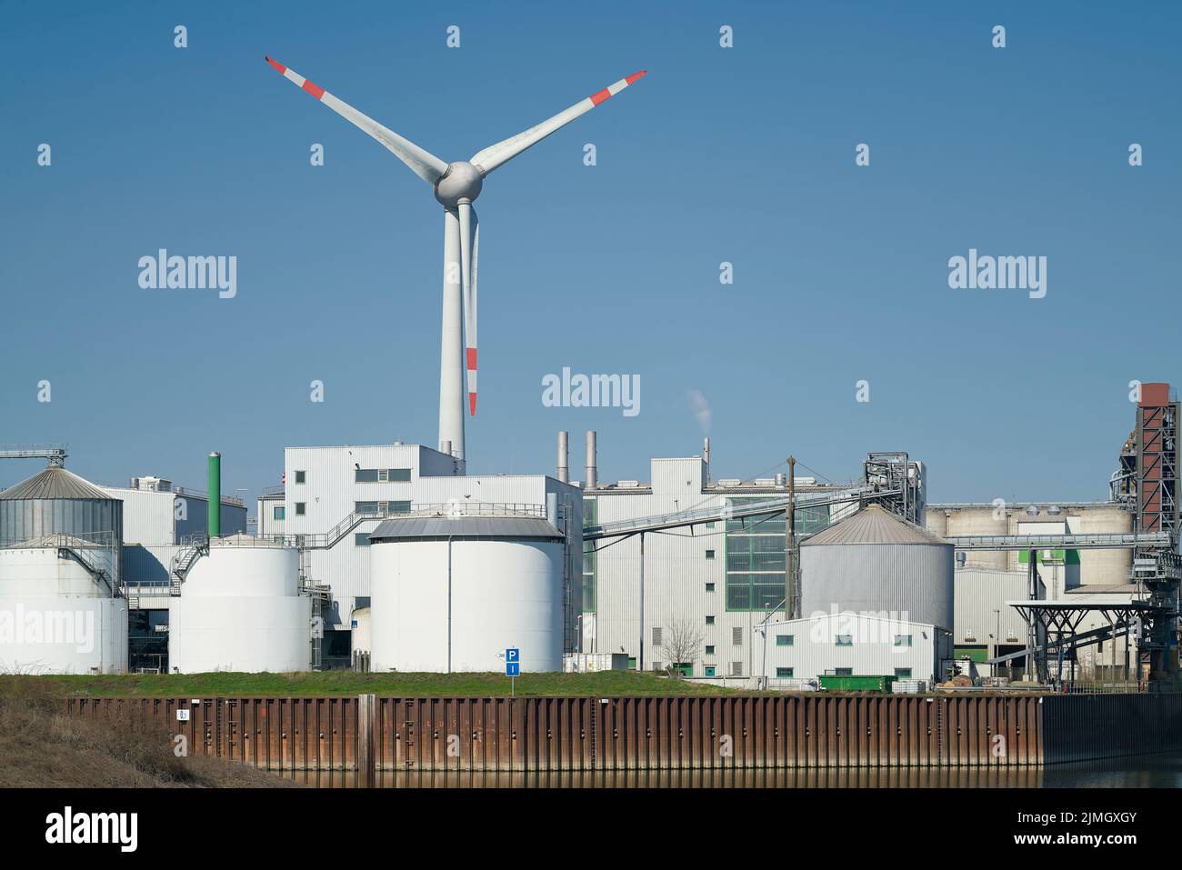 Industrial plant and wind turbine in the Port Kanalhafen of Magdeburg on the river Elbe Stock Photo