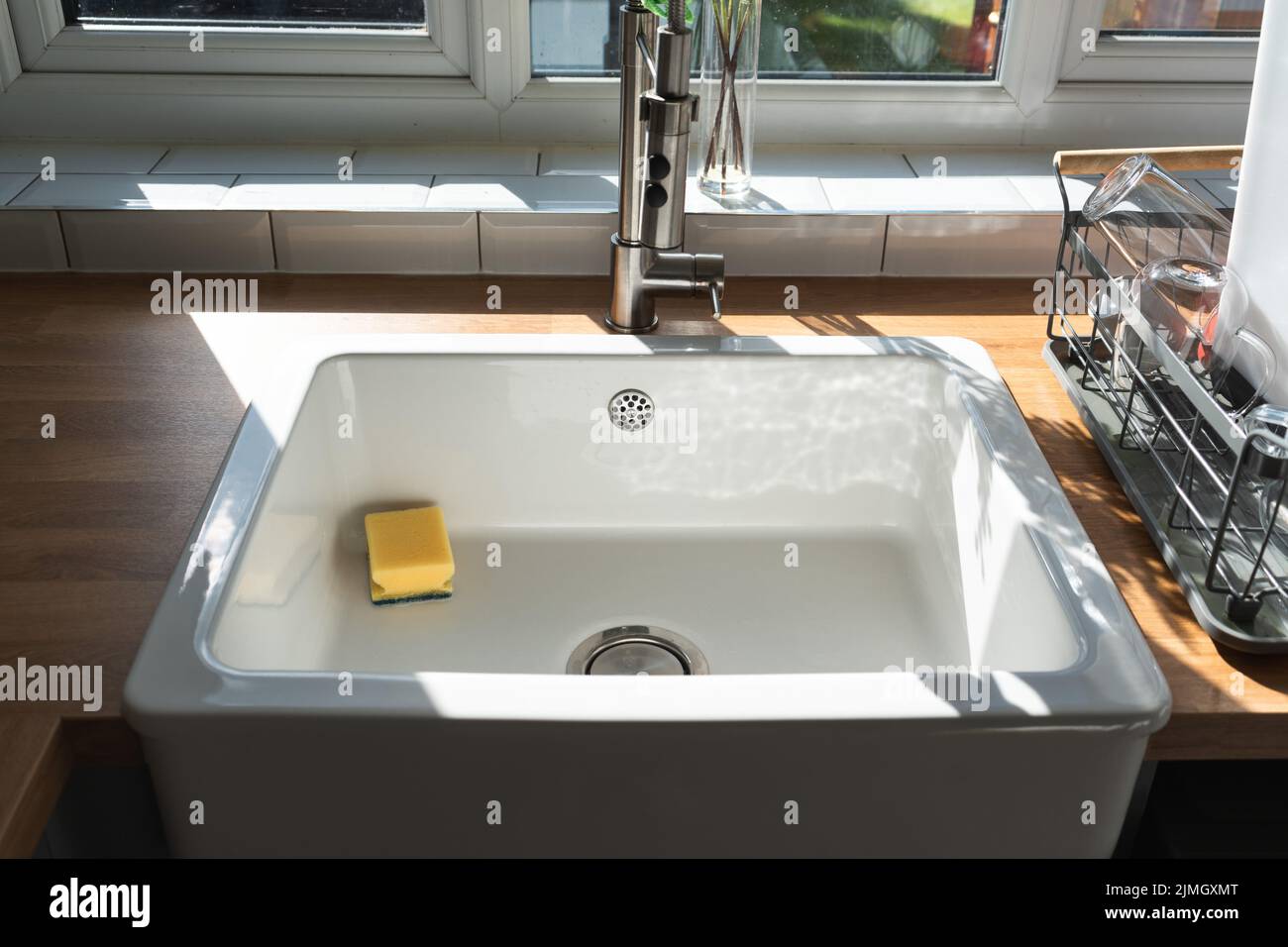 Beautiful white sink belfast style near window in modern kitchen white