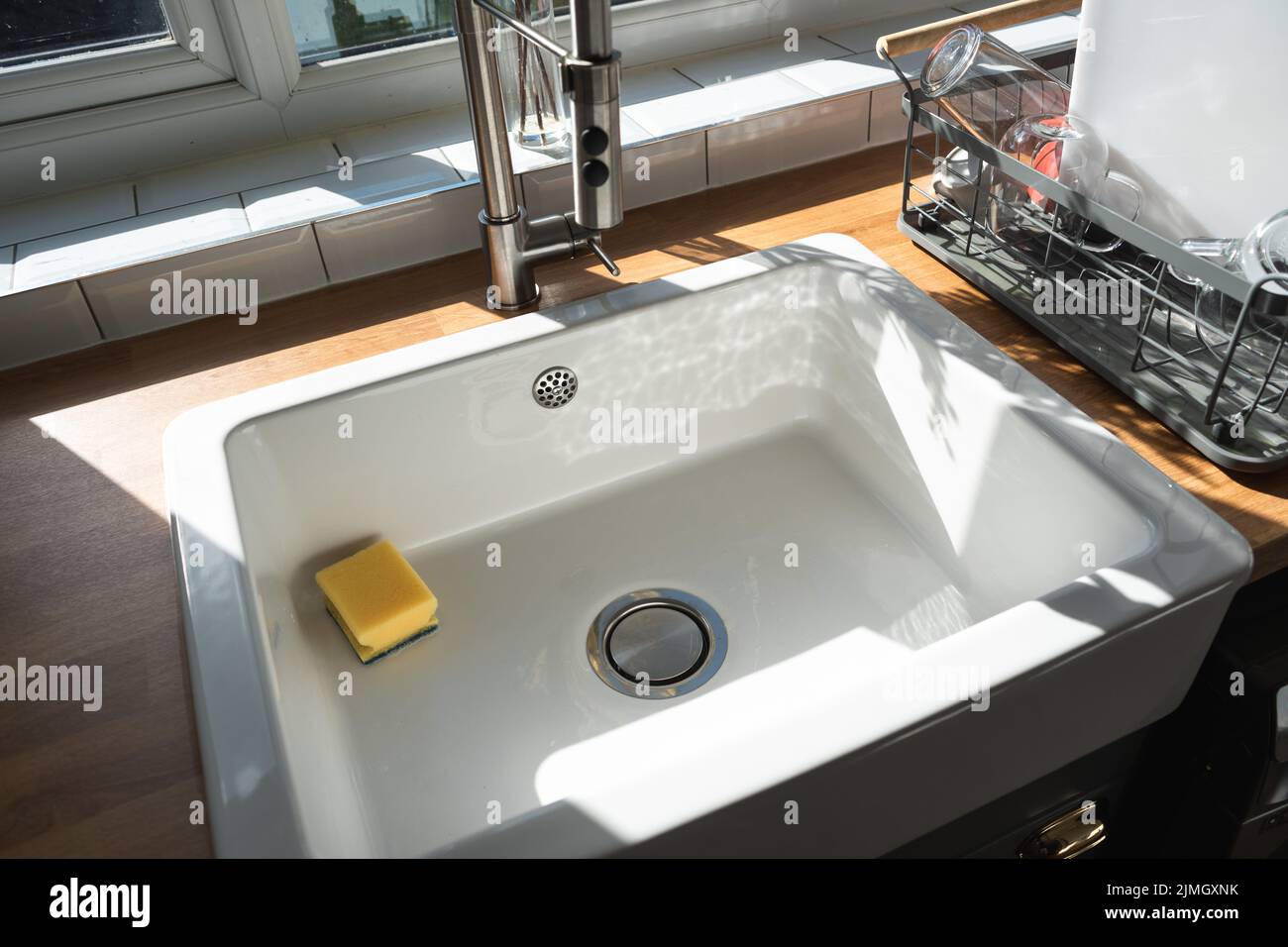 Beautiful white sink belfast style near window in modern kitchen white