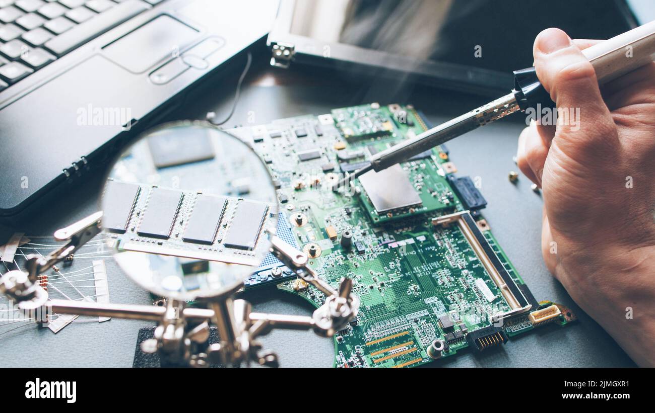 technician repair soldering iron laptop computer Stock Photo Alamy
