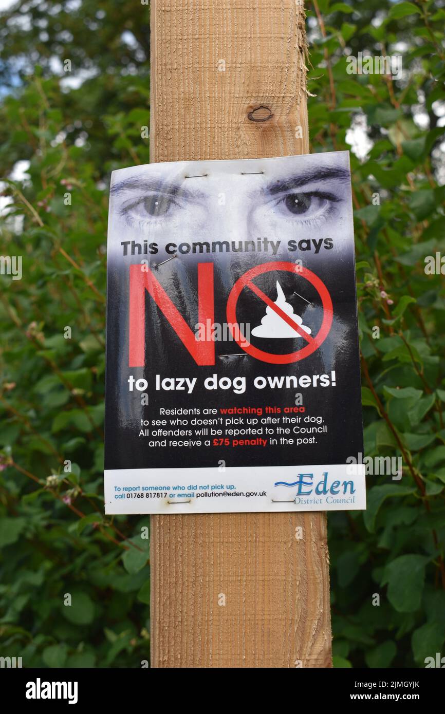 Notice: 'This community says no to lazy dog owners'. Stock Photo