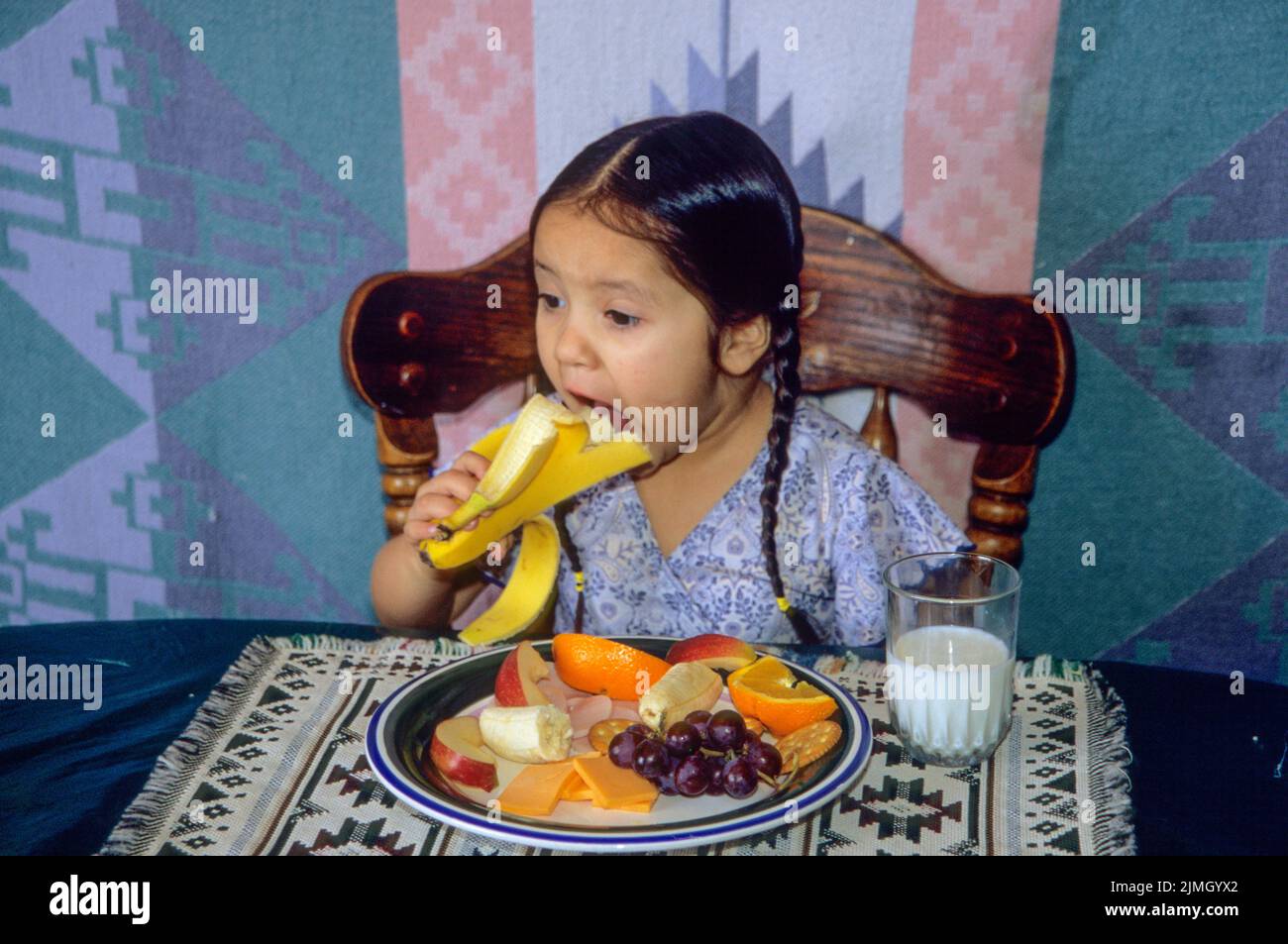 of fruit, cheese and milk while sitting in a chair at a table. Fort Hall Idaho Stock Photo