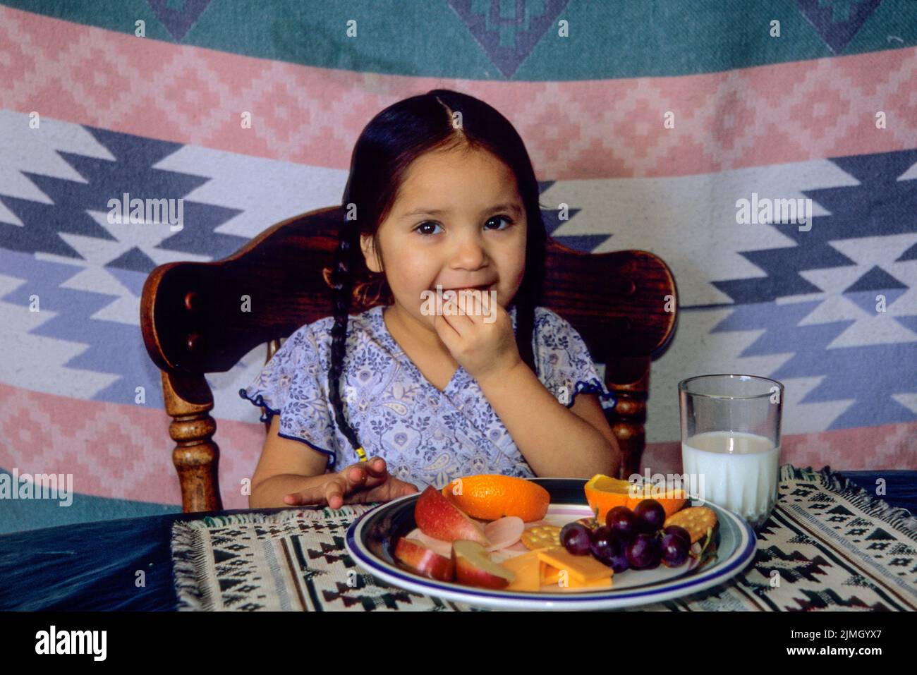 of fruit, cheese and milk while sitting in a chair at a table. Fort Hall Idaho Stock Photo