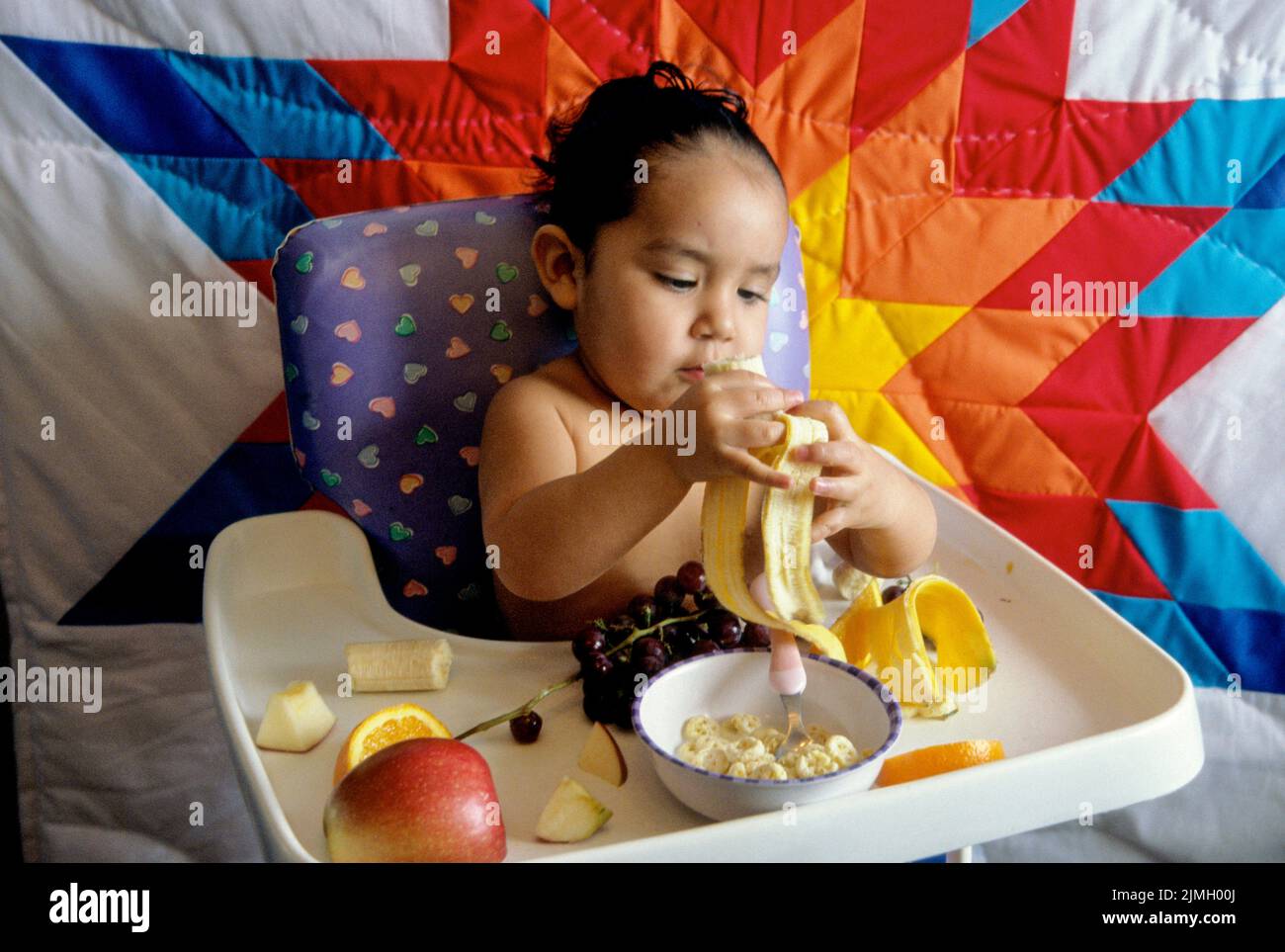 of fruit and cereal while sitting in a high chair. Fort Hall Idaho Stock Photo