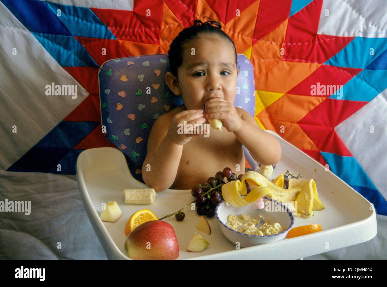 of fruit and cereal while sitting in a high chair. Fort Hall Idaho Stock Photo