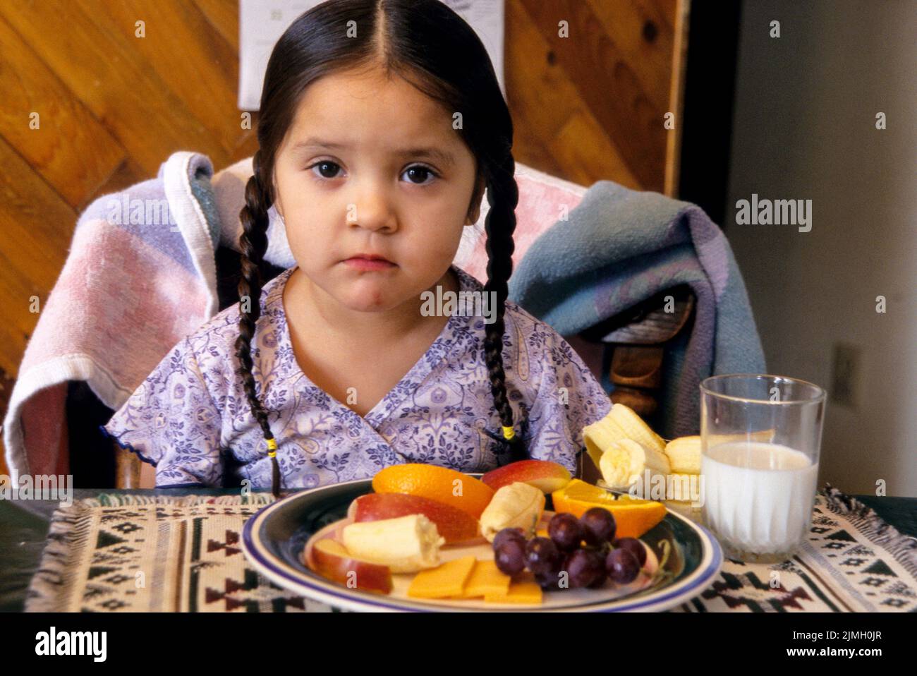 of milk, banana, apple, oranges, grapes and cheese while sitting at a table. Shoshone Bannock Indian Reservation, Fort Hall Idaho Stock Photo