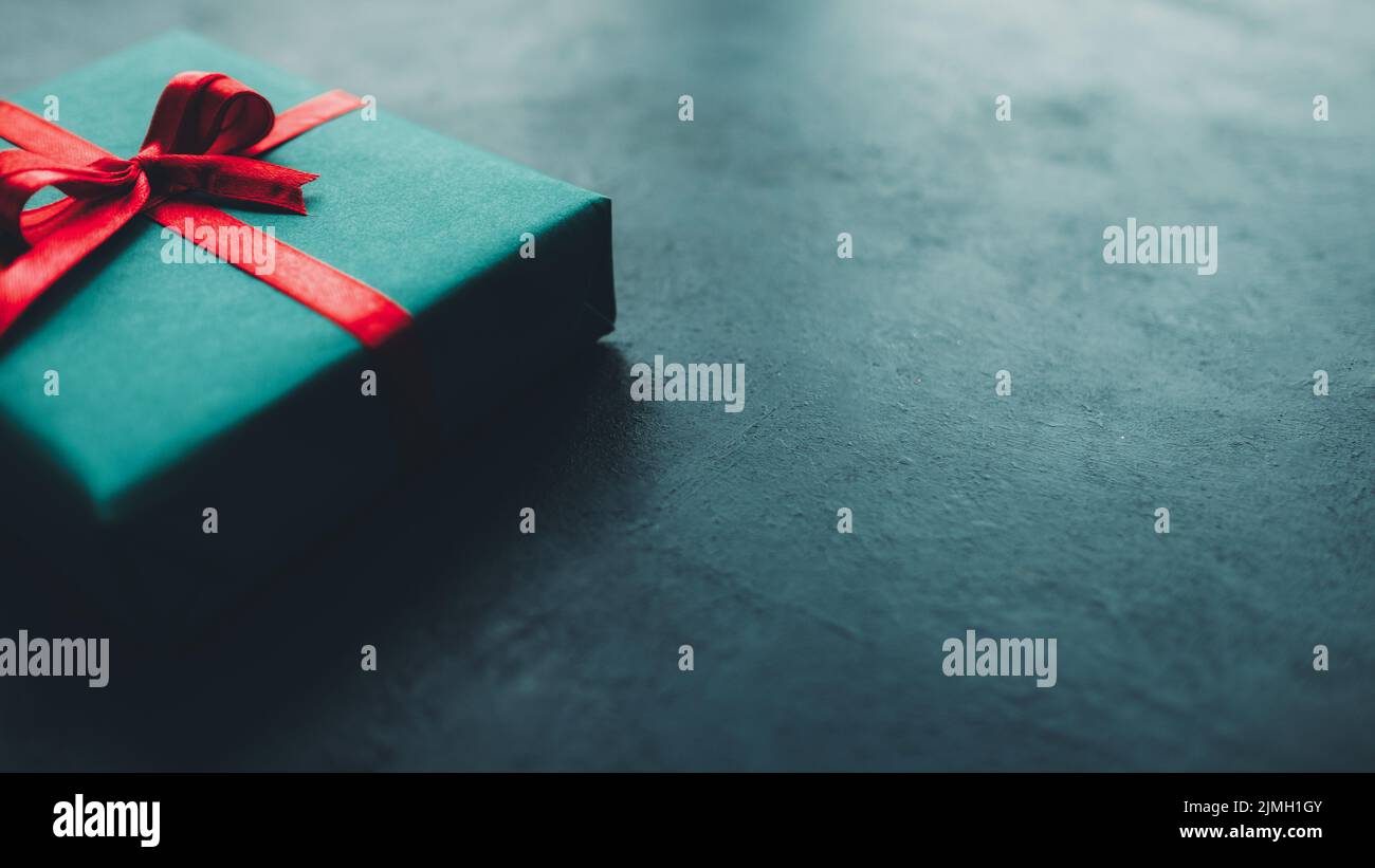 birthday present gift box teal blue background Stock Photo - Alamy