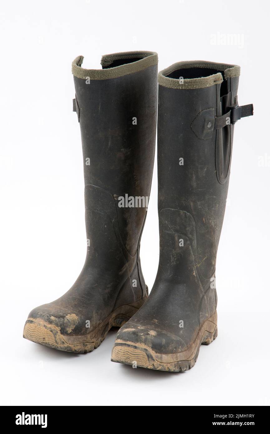 Muddy wellies on a white background Stock Photo