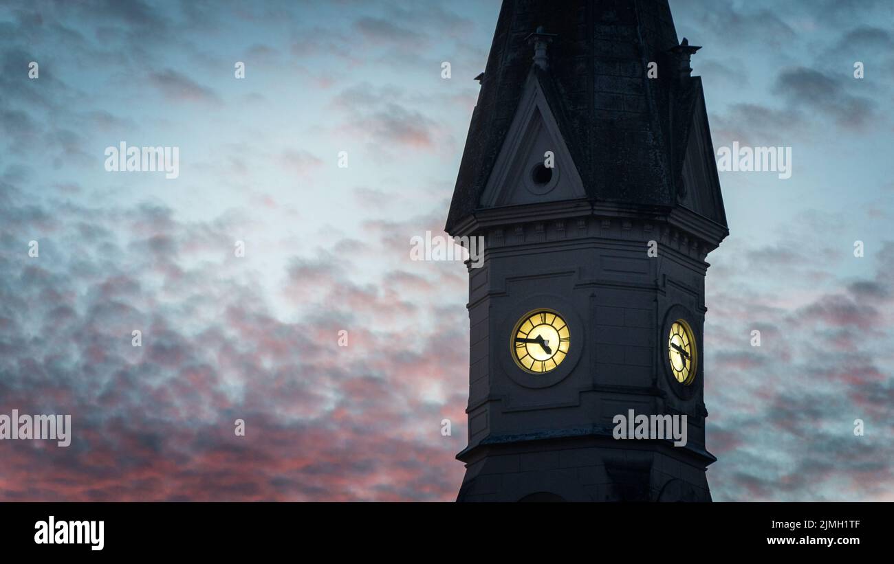 Old church clock against sunset Stock Photo