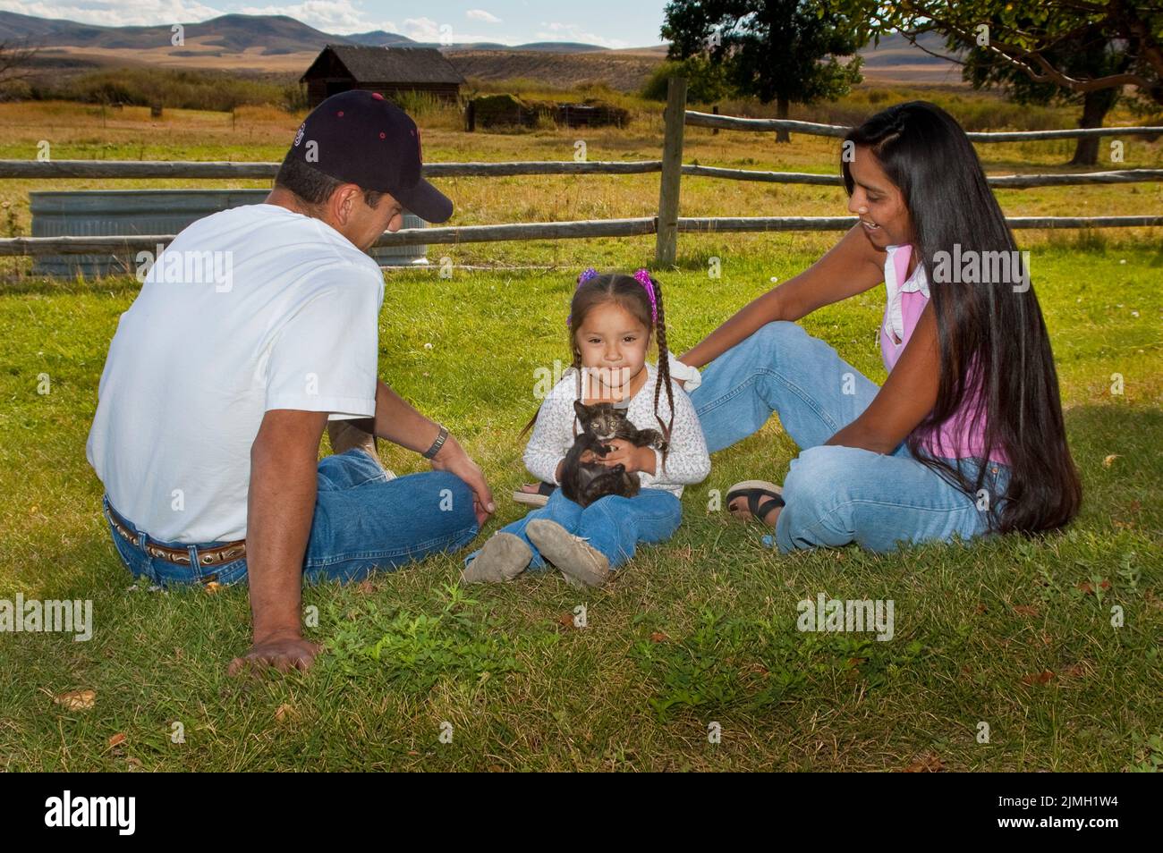 Native American family play with pet kitten, Shoshone Bannock Indian