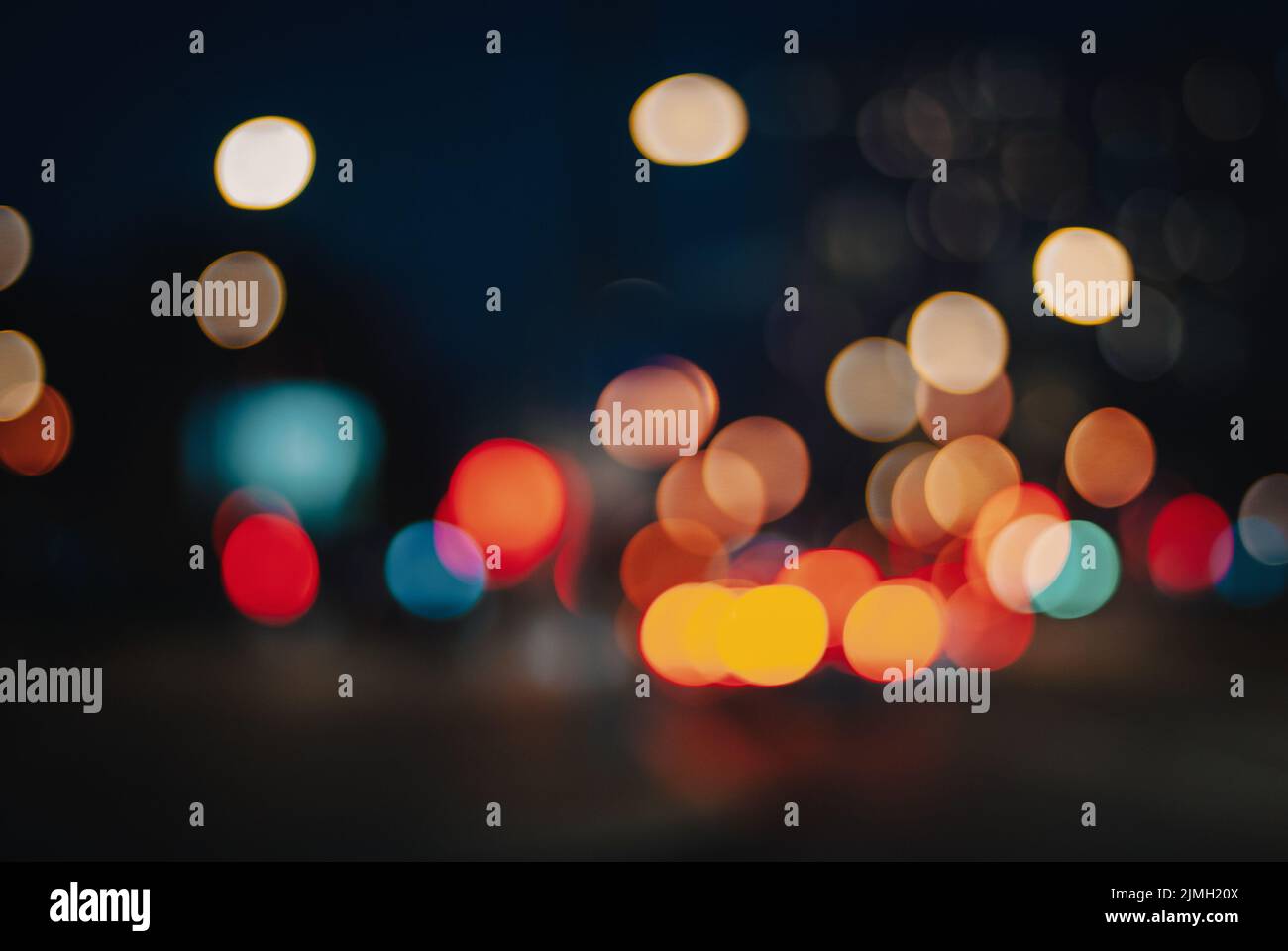 Bokeh street lights at night, blurry city traffic colors background Stock Photo