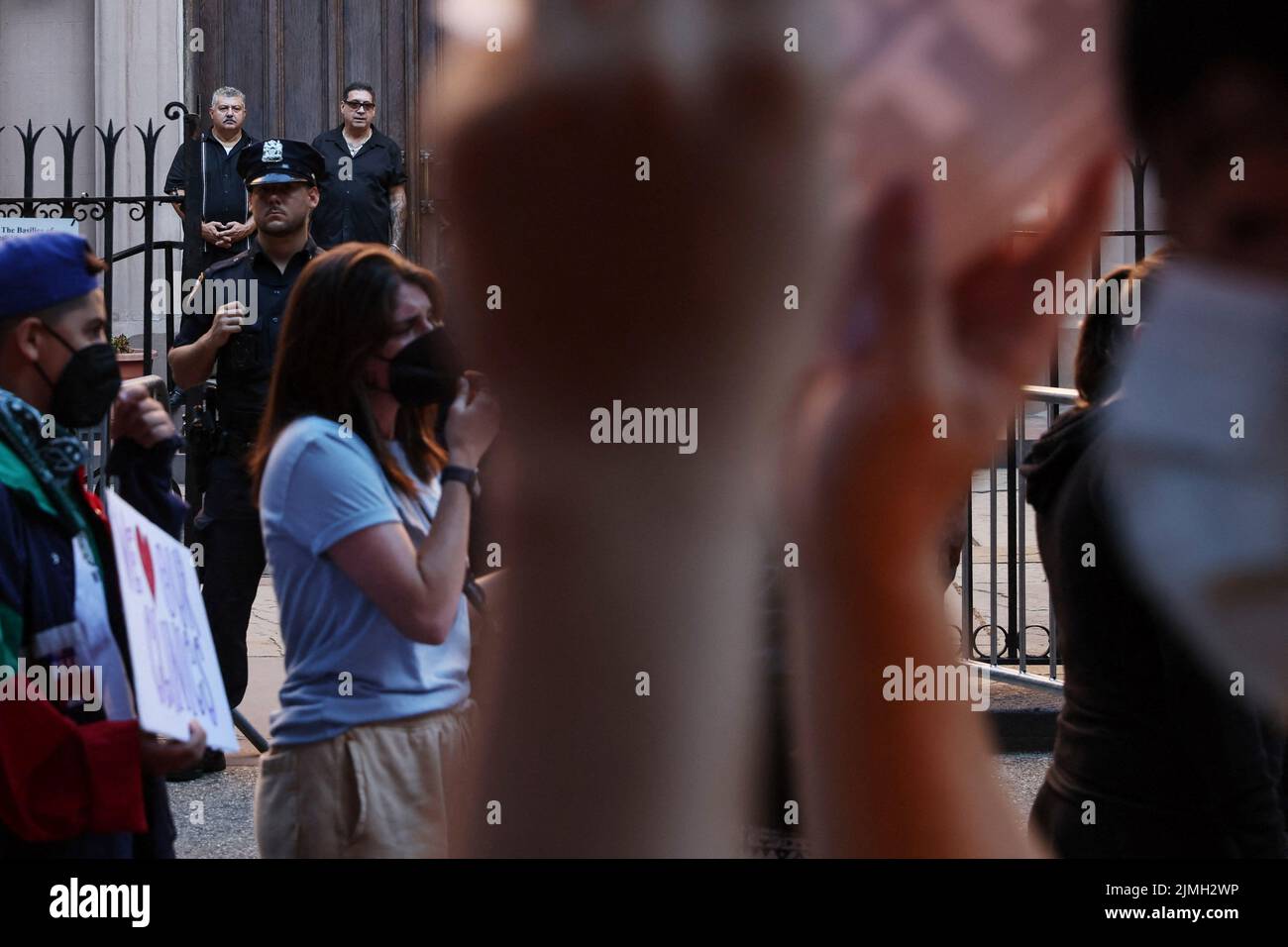 Security guards watch as abortion rights activists march outside St. Patrick's Old Cathedral in New York City,  U.S., August 6, 2022. REUTERS/Shannon Stapleton Stock Photo