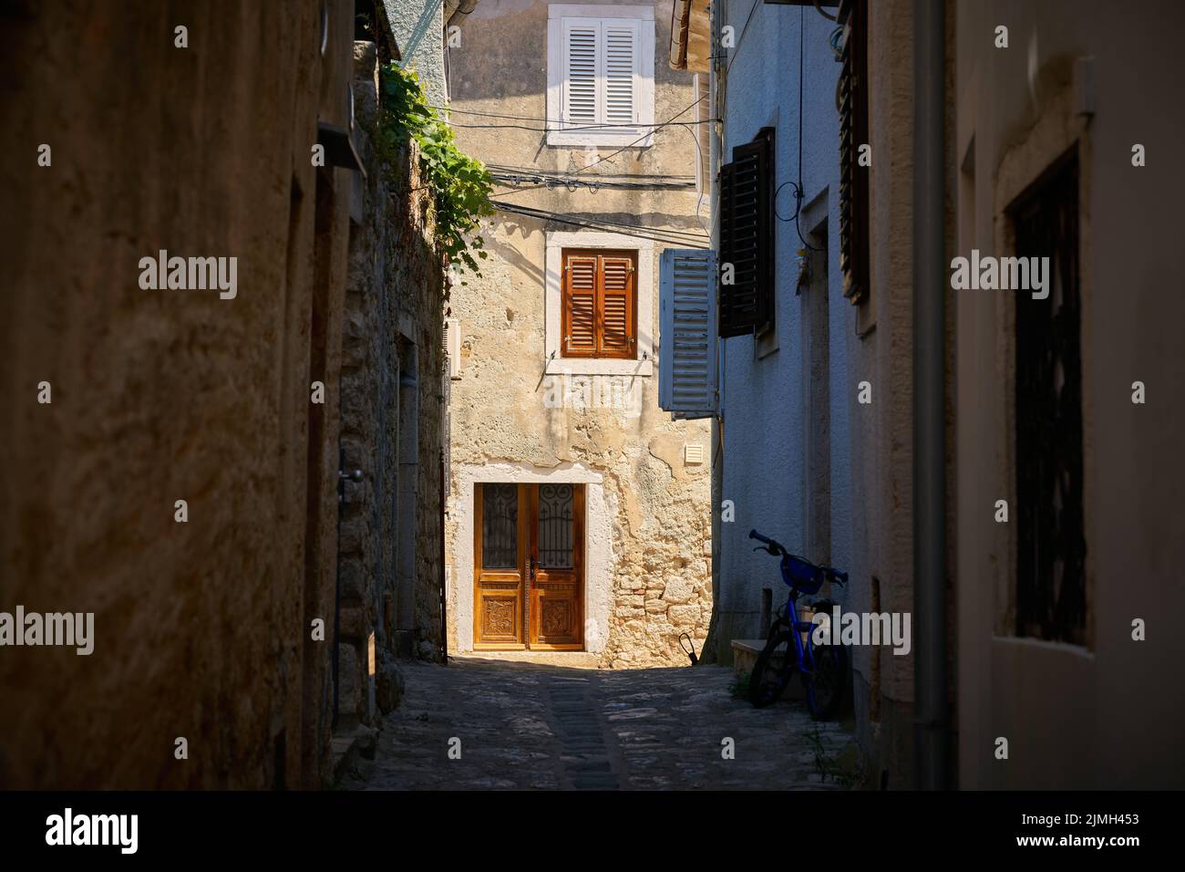 Historical for the region typical house in an alley in the old town of Krk in Croatia Stock Photo