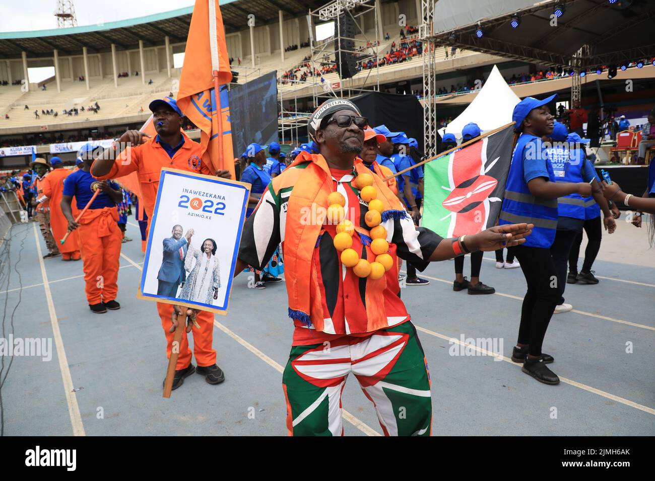 Nairobi, Kenya. 06th Aug, 2022. A supporter of Azimio la Umoja One Kenya presidential candidate Raila Odinga is seen dancing while holding his campaign poster during the final day of campaigns at the Kasarani Stadium in Nairobi. The August 9, 2022 general elections will be his fifth attempt at the presidency. Credit: SOPA Images Limited/Alamy Live News Stock Photo