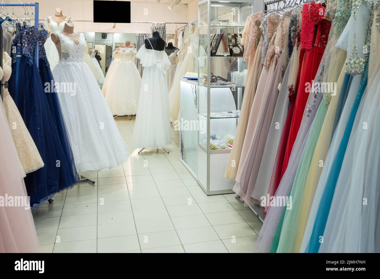 Many different evening and wedding dresses on a hanger in a general store Stock Photo