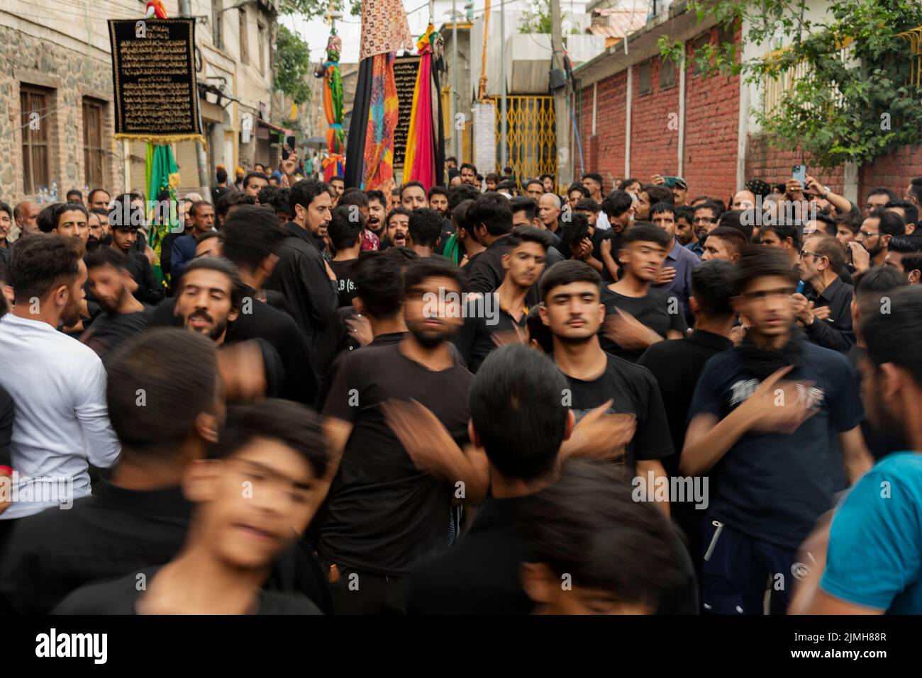 Shia Muslim mourners beat their chests during a religious procession on the 7th day of Muharram. Muharram is the first month of Islam. It is one of the holiest months on the Islamic calendar. Shia Muslims commemorate Muharram as a month of mourning in remembrance of the martyrdom of the Islamic Prophet Muhammad's grandson Imam Hussain, who was killed on Ashura (10th day of Muharram) in the battle of Karbala in 680 A.D. Stock Photo