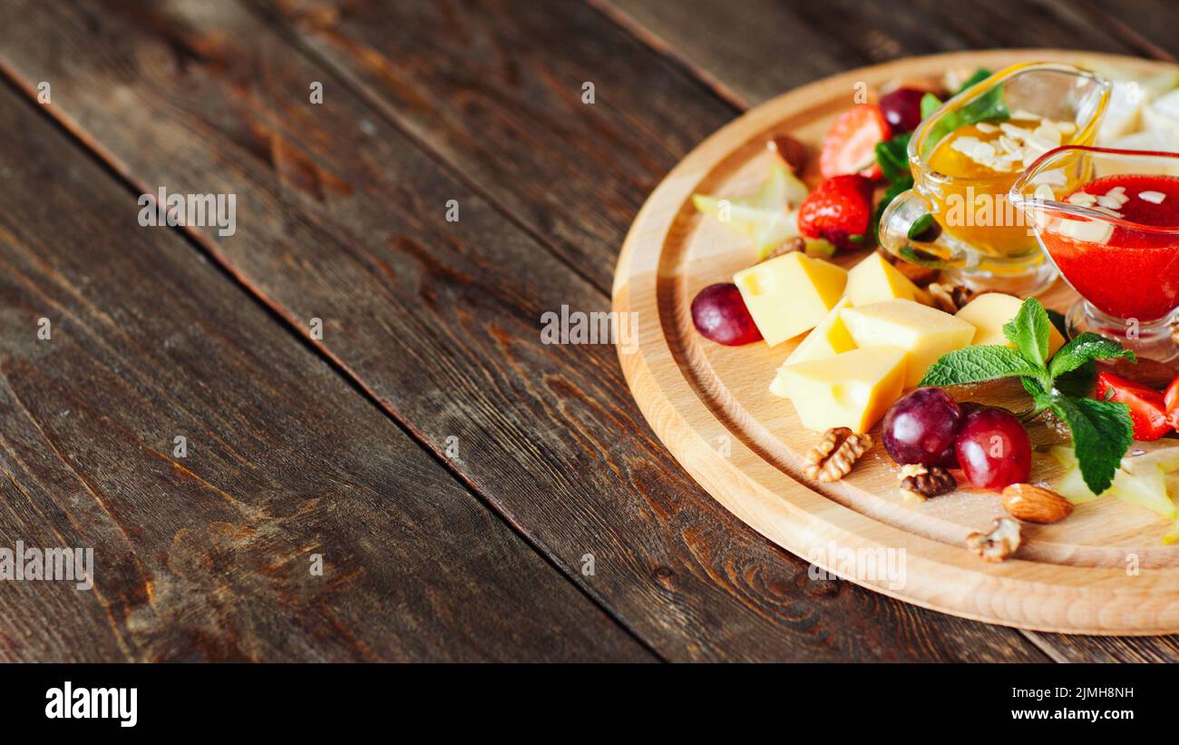 restaurant snack menu cheese plate fruit nuts Stock Photo