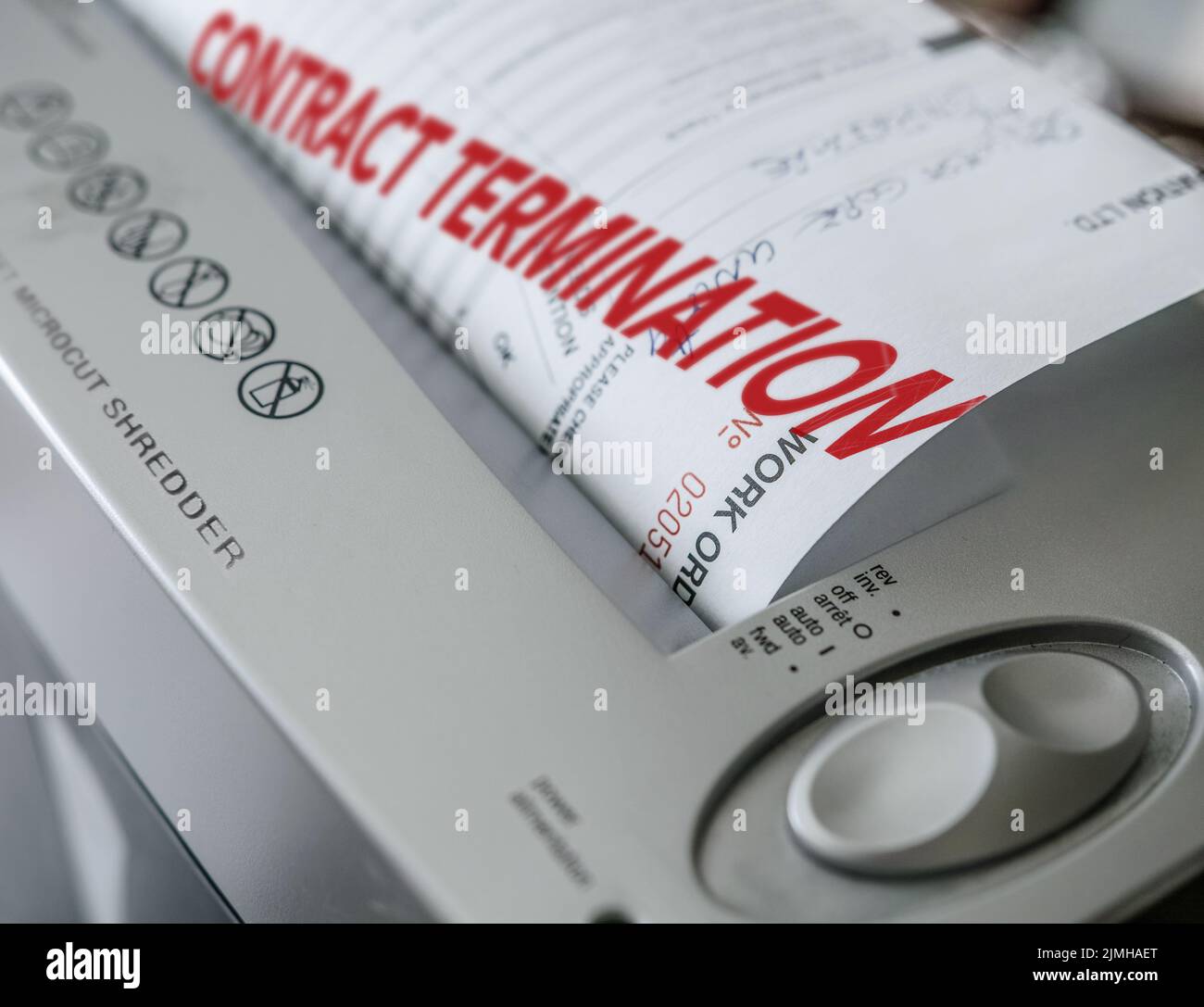 a notice announcing the end of the contract and the destruction of the documents through the shredder.. Stock Photo